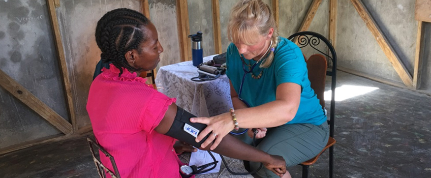 Checking a patient’s blood pressure in in Haiti